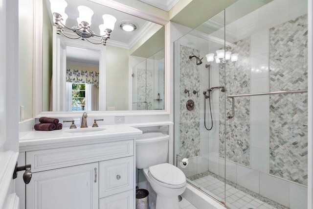 bathroom featuring an inviting chandelier, a shower with shower door, ornamental molding, toilet, and vanity