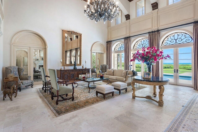 living room featuring a notable chandelier, a high ceiling, and light tile floors