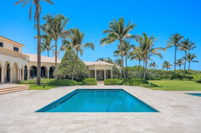 view of swimming pool with a patio area and a lawn