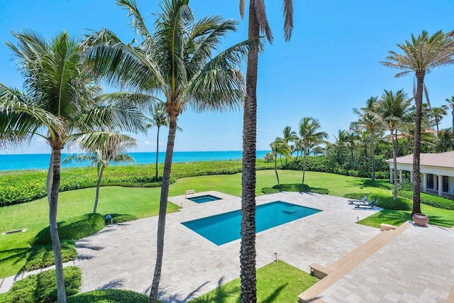 view of pool with a yard, an in ground hot tub, a water view, and a patio