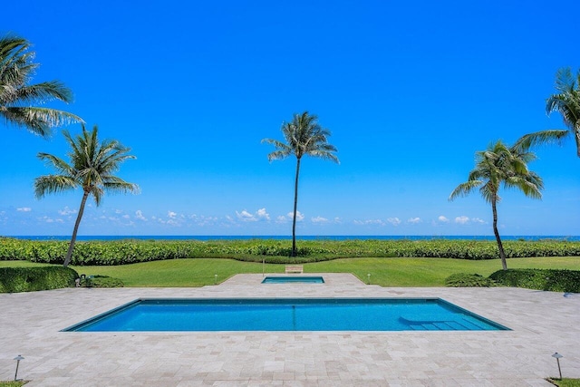 outdoor pool featuring a patio and a lawn