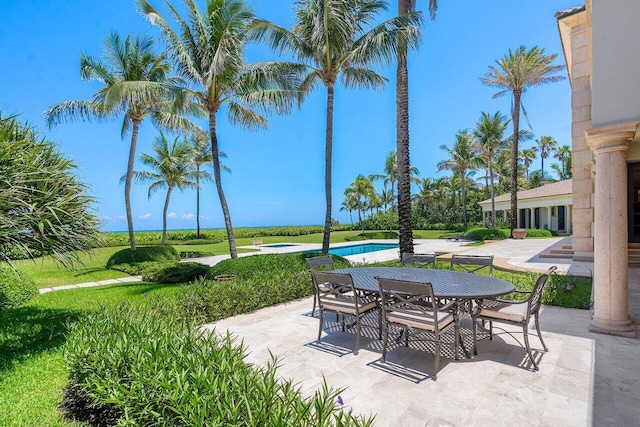 view of patio / terrace with outdoor dining area and an outdoor pool