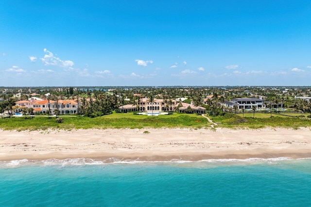 drone / aerial view featuring a water view, a residential view, and a view of the beach