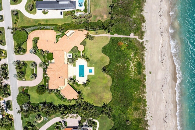 drone / aerial view featuring a view of the beach and a water view