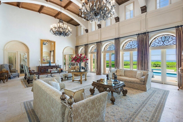 living room with beamed ceiling, wood ceiling, light tile floors, a towering ceiling, and a chandelier