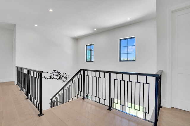 stairs featuring a healthy amount of sunlight and wood-type flooring