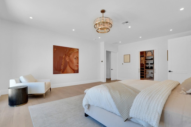 bedroom with hardwood / wood-style floors, a closet, and a spacious closet