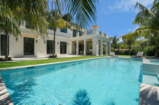 view of pool with french doors and a patio