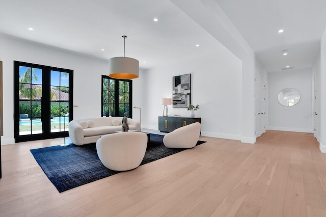 living room with light hardwood / wood-style floors and french doors