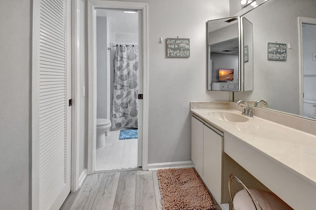 bathroom featuring vanity, curtained shower, toilet, and wood-type flooring