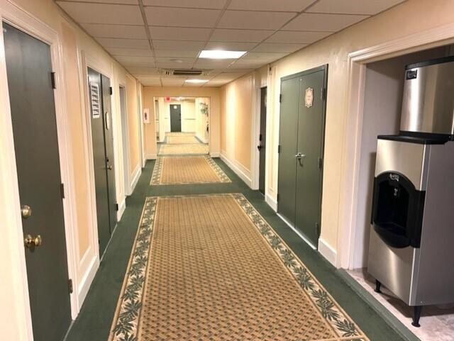 hallway with a paneled ceiling