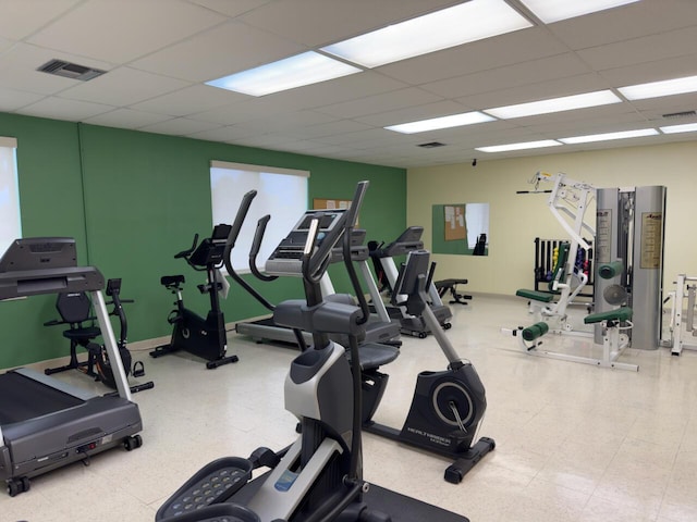 gym featuring a drop ceiling, visible vents, and tile patterned floors