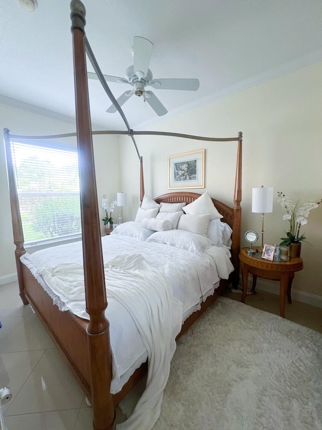 tiled bedroom featuring ceiling fan and crown molding