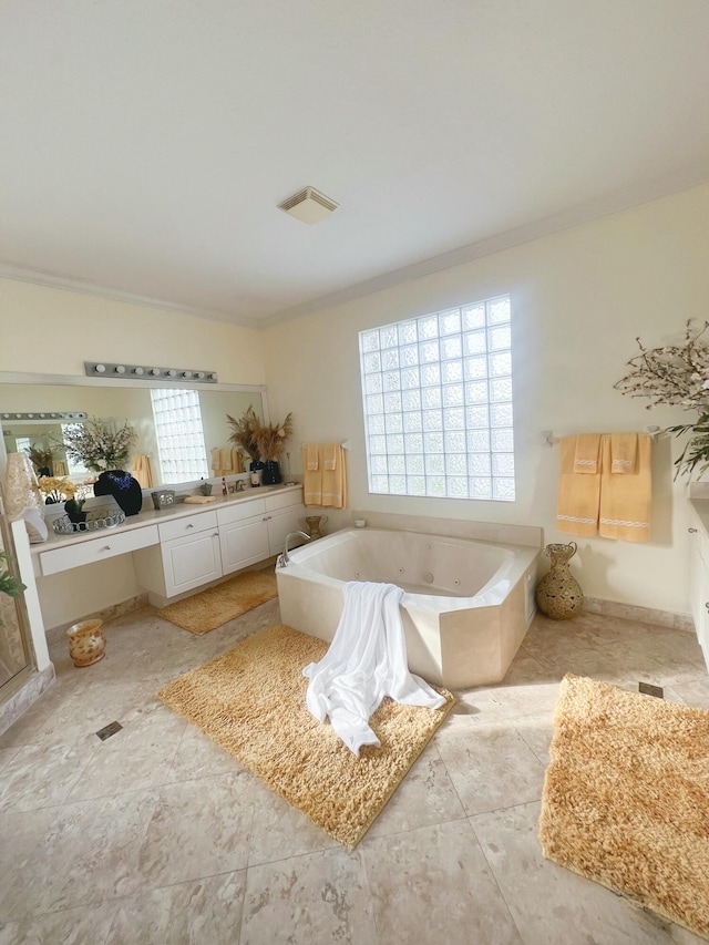 bathroom featuring vanity, a bathtub, and crown molding