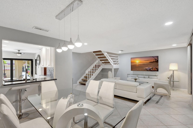 living room featuring light tile patterned floors and a textured ceiling