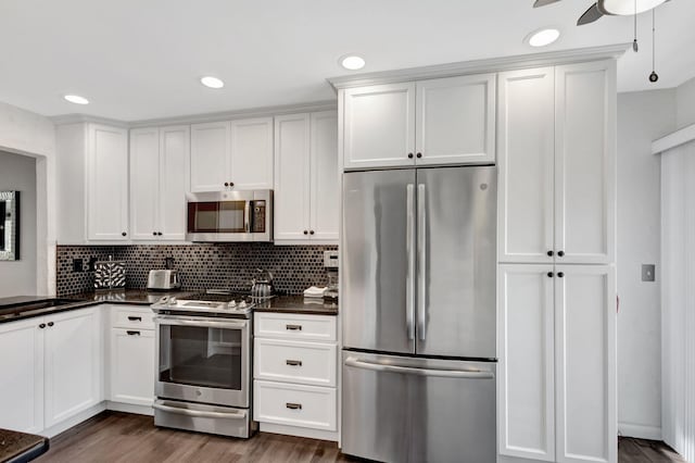 kitchen featuring tasteful backsplash, dark hardwood / wood-style flooring, white cabinets, and stainless steel appliances