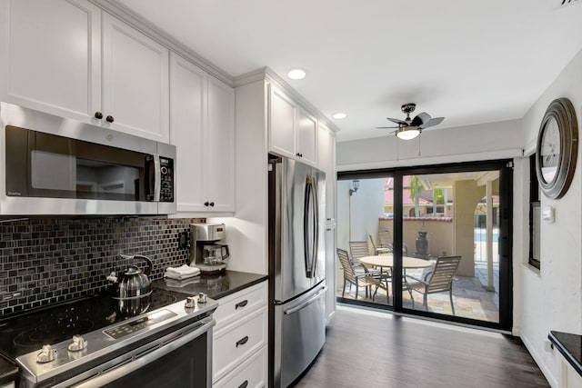 kitchen featuring backsplash, white cabinets, dark hardwood / wood-style floors, ceiling fan, and appliances with stainless steel finishes