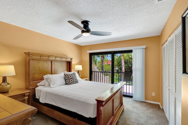 bedroom featuring access to exterior, ceiling fan, carpet floors, a textured ceiling, and a closet