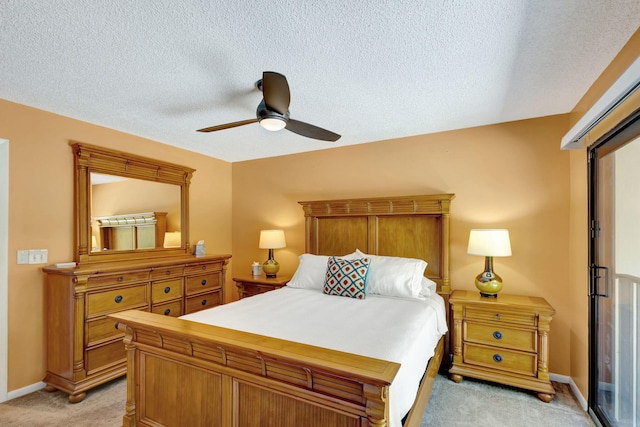 bedroom featuring light carpet, ceiling fan, and a textured ceiling