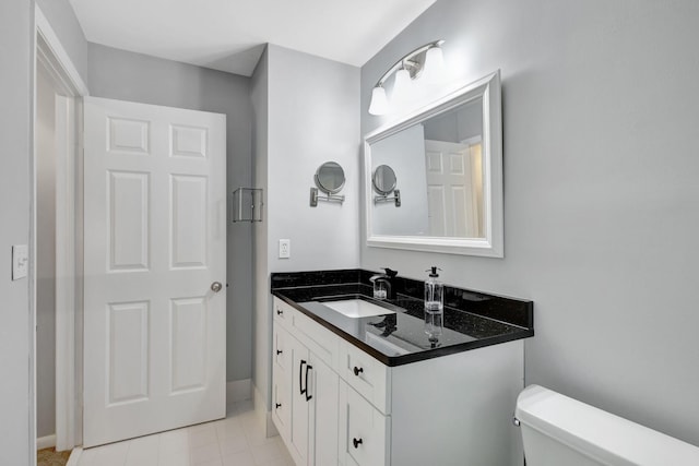 bathroom featuring tile patterned floors, vanity, and toilet