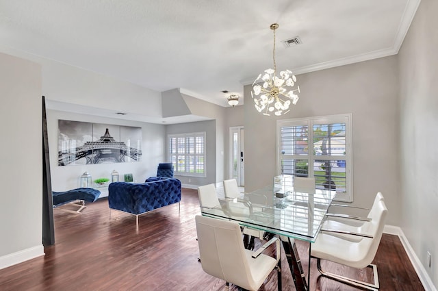 dining room featuring ornamental molding, a healthy amount of sunlight, dark hardwood / wood-style floors, and an inviting chandelier