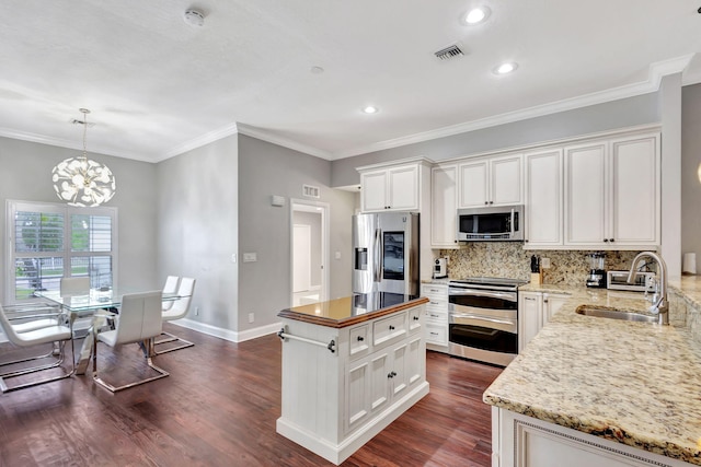 kitchen with dark hardwood / wood-style flooring, a center island, stainless steel appliances, and white cabinetry