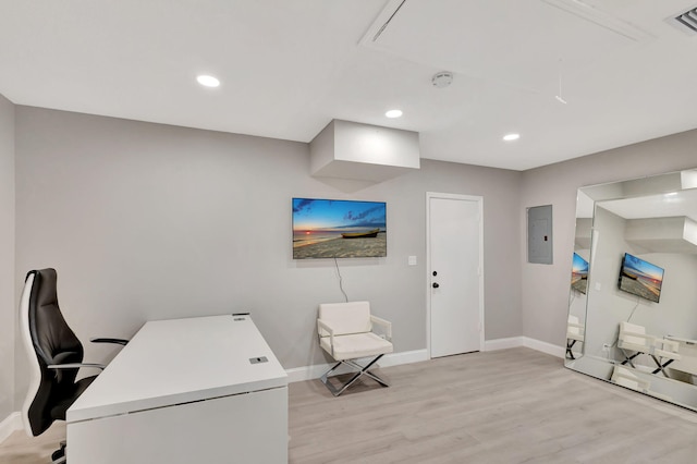 office area with electric panel and light hardwood / wood-style flooring