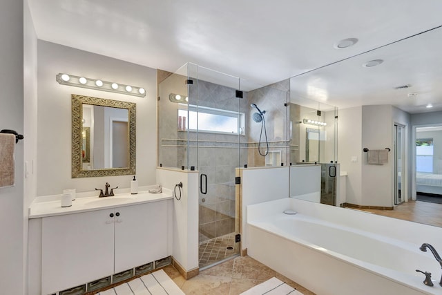 bathroom featuring tile patterned flooring, vanity, and separate shower and tub