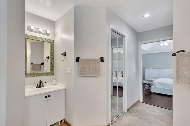 bathroom featuring hardwood / wood-style floors, vanity, and ceiling fan