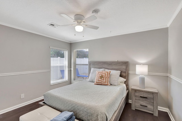 bedroom with ceiling fan, dark hardwood / wood-style flooring, ornamental molding, and a textured ceiling