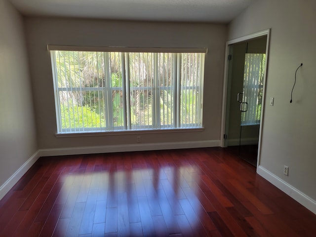 spare room featuring dark hardwood / wood-style floors