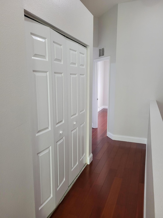 hallway with dark hardwood / wood-style flooring