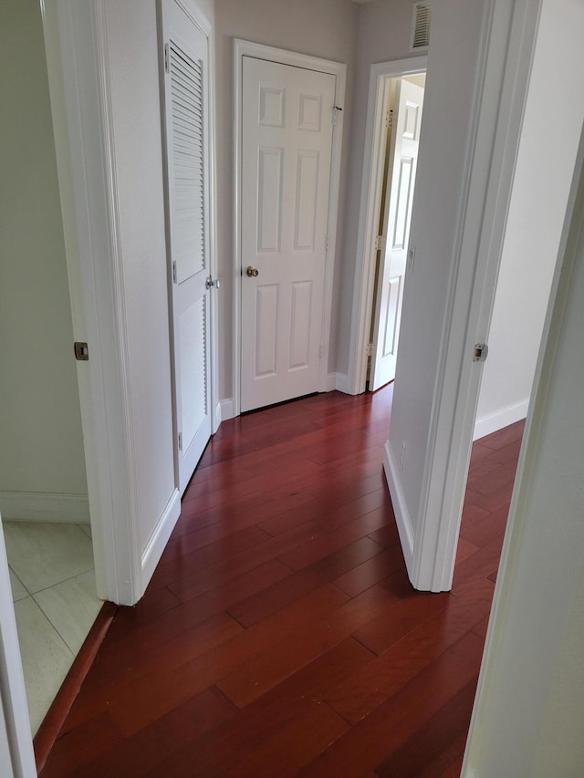 corridor featuring dark hardwood / wood-style floors