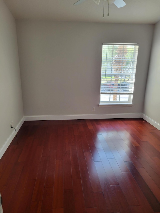 spare room with ceiling fan and dark wood-type flooring