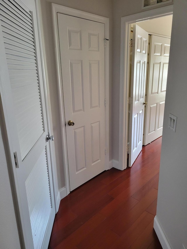 hall with dark wood-type flooring