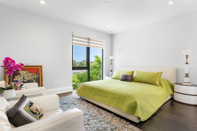 bedroom with dark wood-type flooring