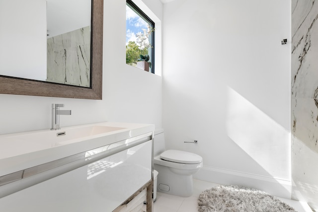 bathroom featuring vanity, toilet, and tile floors