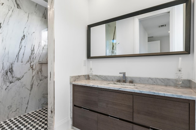 bathroom featuring tile flooring and vanity