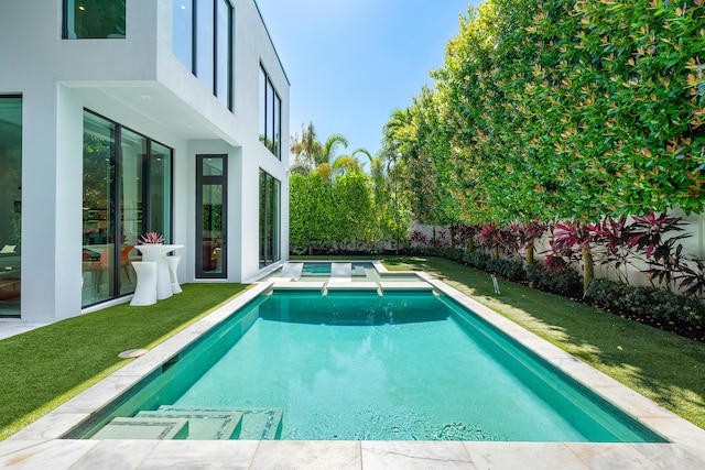 view of pool featuring a lawn