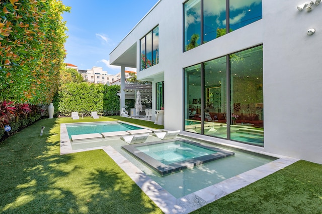 view of swimming pool featuring an in ground hot tub and a lawn