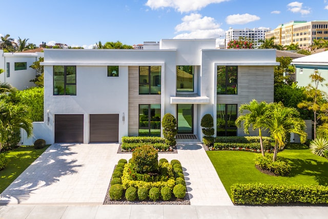 contemporary house with a front yard and a garage