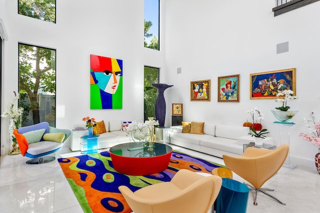 living room featuring a towering ceiling and tile floors