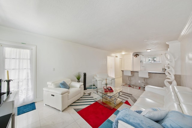 living room featuring ornamental molding and light tile flooring