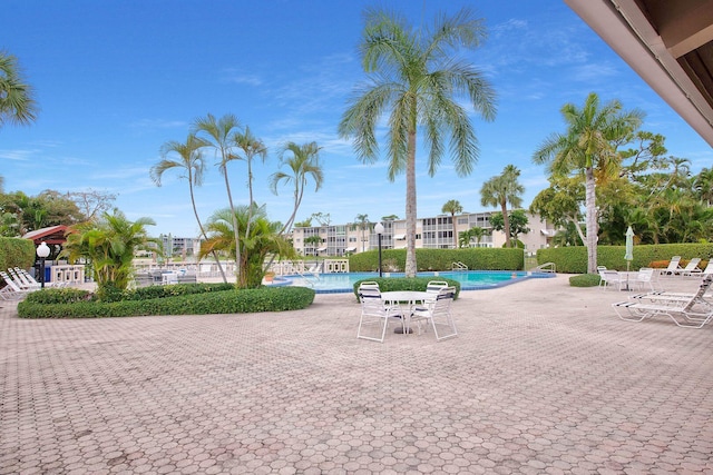 view of home's community featuring a pool and a patio area