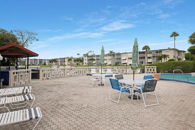 view of home's community with a pool and a patio area