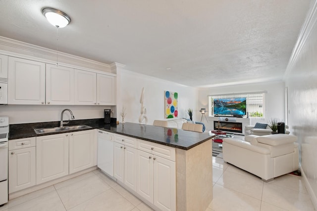 kitchen featuring sink, kitchen peninsula, crown molding, and white appliances