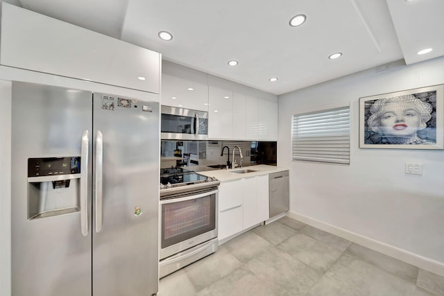 kitchen featuring white cabinets, stainless steel appliances, and sink