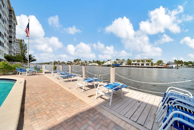 dock area featuring a water view, a patio area, and a community pool