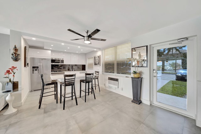 dining room featuring heating unit and ceiling fan