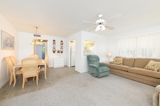 carpeted living room featuring a textured ceiling, plenty of natural light, and ceiling fan with notable chandelier